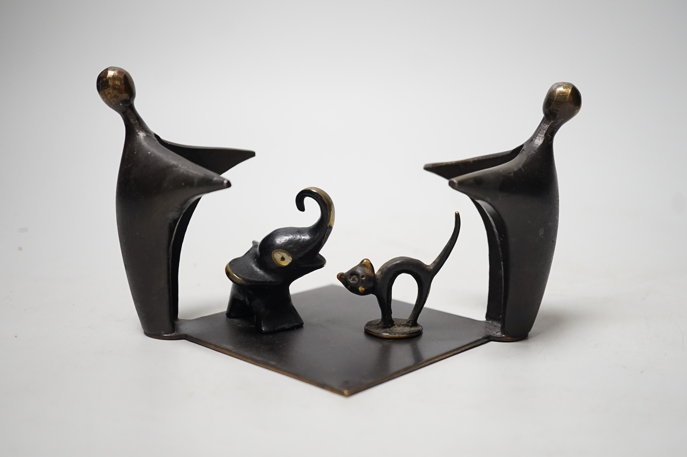 An abstract bronze group, 19cm wide, together with two other figures